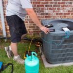 ac repairman checking condenser