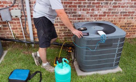 ac repairman checking condenser